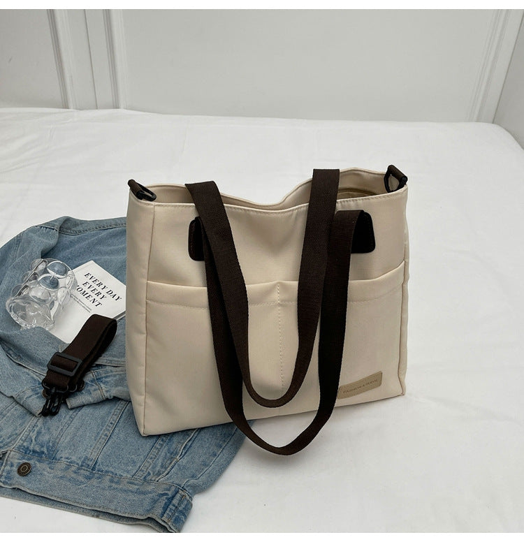 Stylish khaki canvas tote bag with detachable shoulder strap