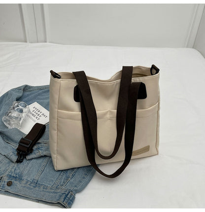 Stylish khaki canvas tote bag with detachable shoulder strap